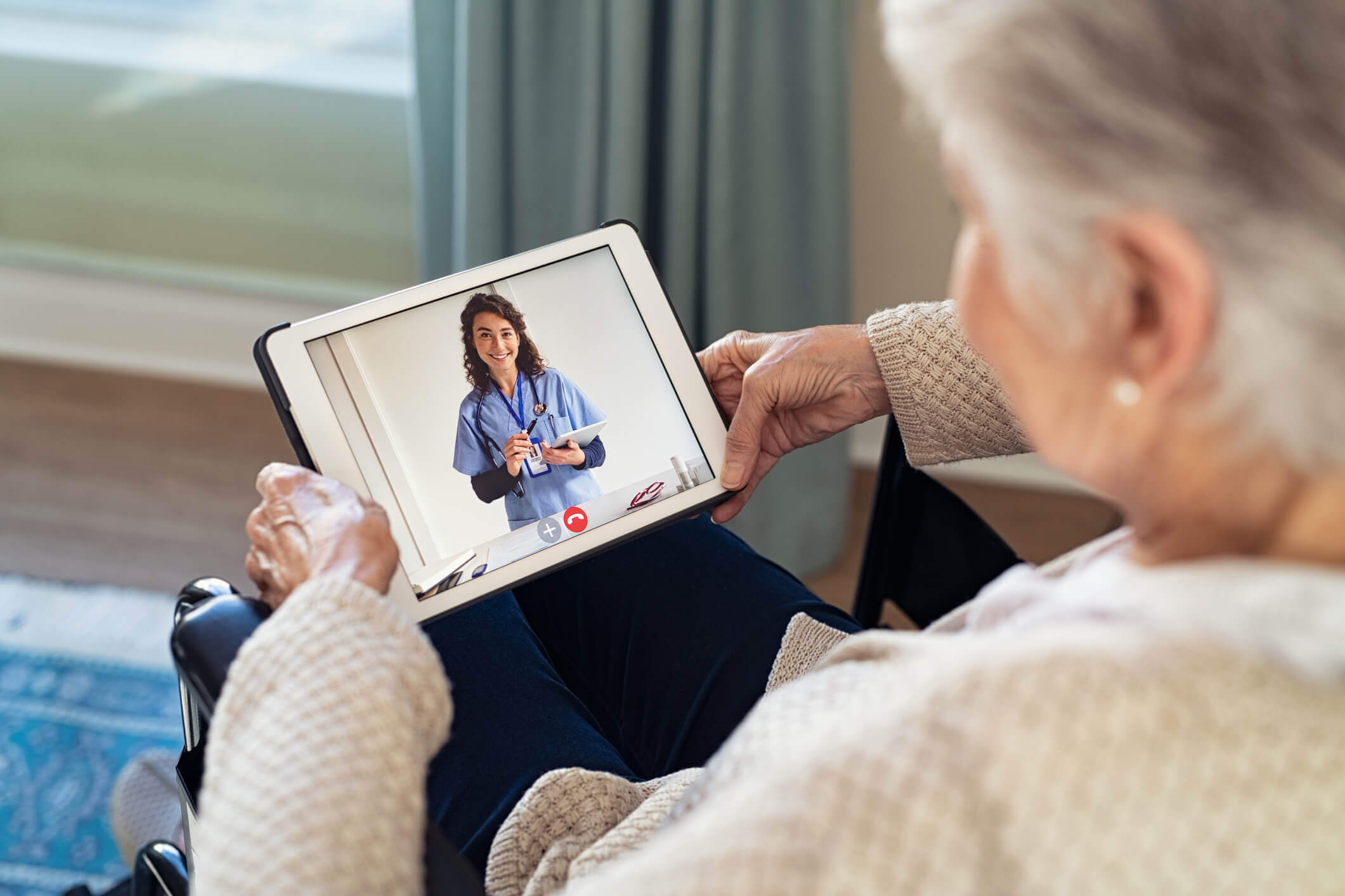 A old woman taking telemedicine consultation